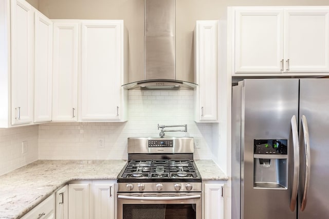 108 High St, Portland, TN 37148 - kitchen with stainless steel appliances, wall chimney range hood, white cabinetry, and backsplash