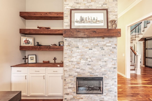 108 High St, Portland, TN 37148 - detailed view of wood finished floors, a stone fireplace, ornamental molding, and baseboards