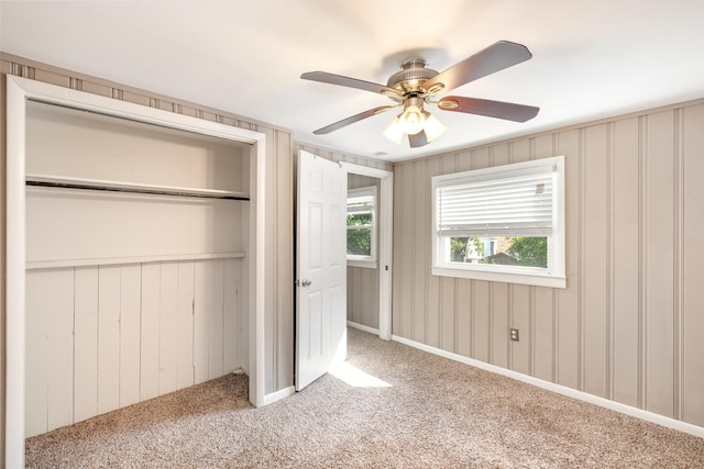 unfurnished bedroom featuring a closet, ceiling fan, and carpet flooring