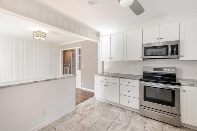 kitchen with ceiling fan, light stone counters, stainless steel appliances, white cabinetry, and tasteful backsplash