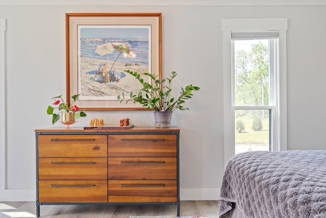 bedroom featuring baseboards and wood finished floors