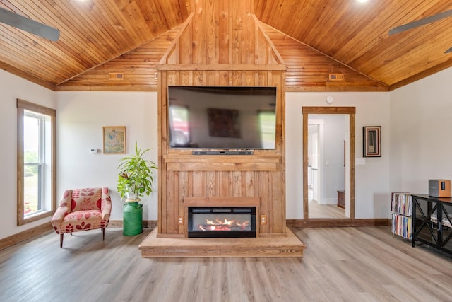 living area with a glass covered fireplace, wood finished floors, baseboards, wood ceiling, and vaulted ceiling