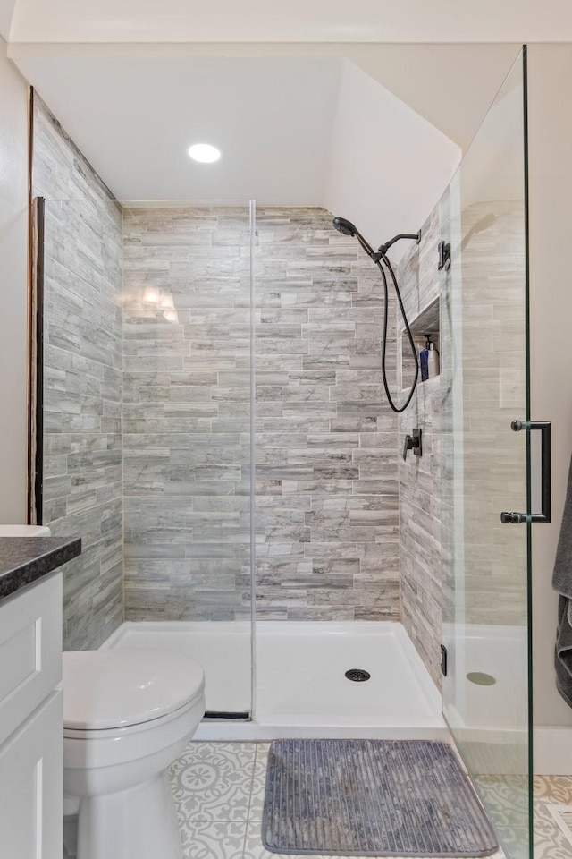full bathroom featuring tile patterned flooring, vanity, toilet, recessed lighting, and a shower stall