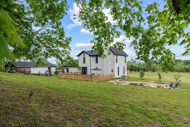 view of yard featuring an outdoor fire pit and a deck