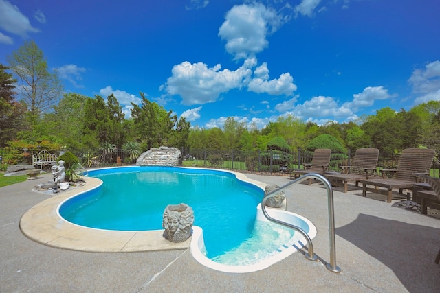 view of swimming pool with a fenced in pool, fence, and a patio