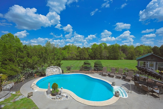 view of swimming pool with a fenced in pool, fence, a yard, and a patio area