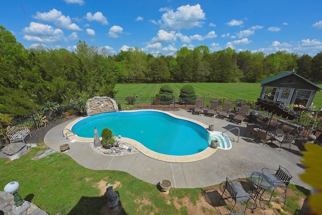 view of pool with a yard, fence, a patio area, and a fenced in pool