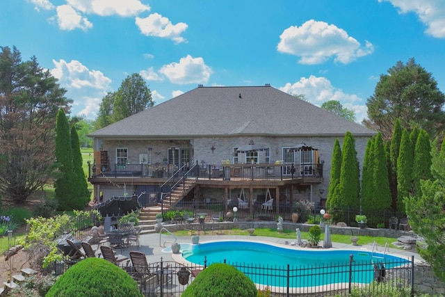 back of property featuring a deck, a patio area, stairway, fence, and a fenced in pool