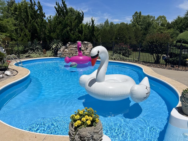 view of swimming pool featuring fence and a fenced in pool