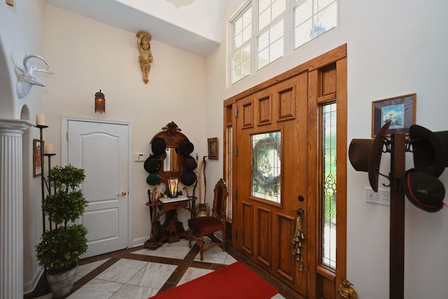 foyer with a high ceiling and baseboards