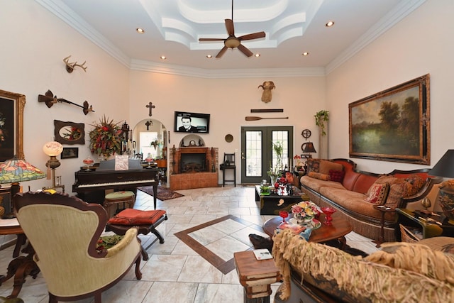 living area featuring a high ceiling, ornamental molding, a ceiling fan, and recessed lighting