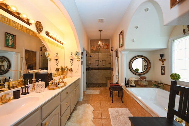 bathroom featuring a bath, a stall shower, vanity, tile patterned floors, and a chandelier