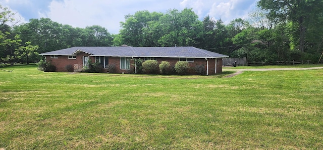 ranch-style home featuring brick siding and a front yard