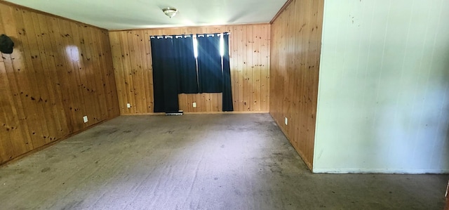 spare room featuring wooden walls