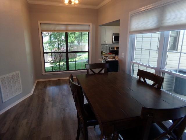 801 Laurel Hill Dr Unit 801, Old Hickory, TN 37138 - dining space featuring baseboards, ornamental molding, dark wood finished floors, and visible vents