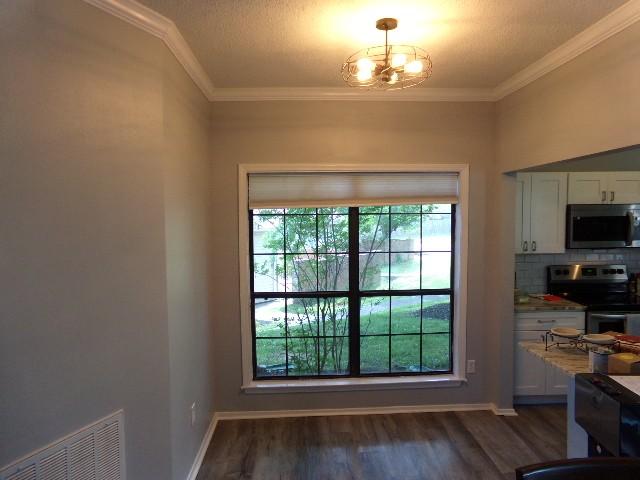 801 Laurel Hill Dr Unit 801, Old Hickory, TN 37138 - doorway featuring visible vents, ornamental molding, and dark wood-style flooring