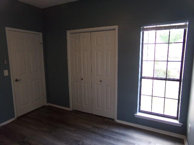 801 Laurel Hill Dr Unit 801, Old Hickory, TN 37138 - unfurnished bedroom with baseboards, wood finished floors, and a closet