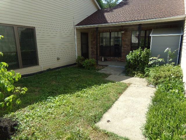 801 Laurel Hill Dr Unit 801, Old Hickory, TN 37138 - doorway to property featuring roof with shingles, a yard, and brick siding