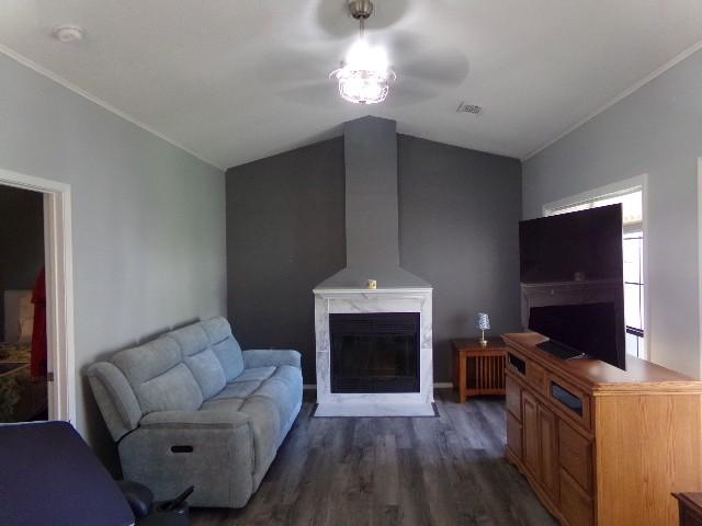 801 Laurel Hill Dr Unit 801, Old Hickory, TN 37138 - living area featuring visible vents, crown molding, lofted ceiling, a fireplace, and dark wood-style floors