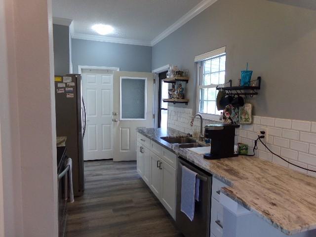 801 Laurel Hill Dr Unit 801, Old Hickory, TN 37138 - kitchen with white cabinets, crown molding, a sink, dishwasher, and range