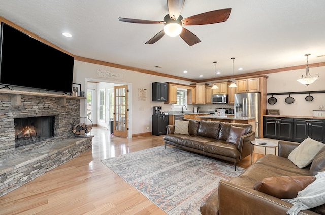 195 Spring Creek Ln, Lebanon, TN 37090 - living room featuring crown molding, a fireplace, light wood-style floors, baseboards, and ceiling fan