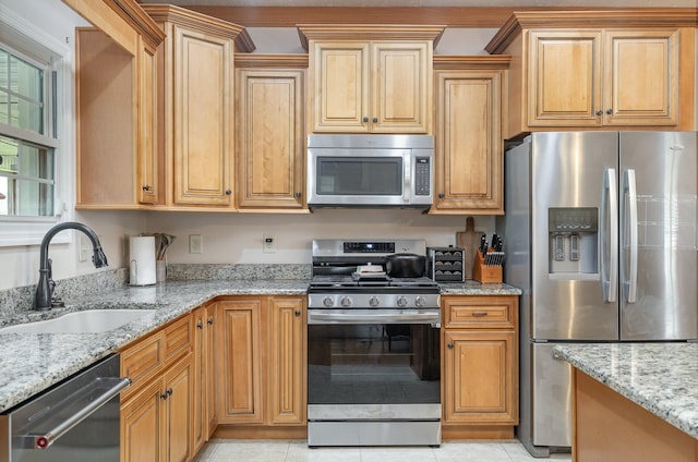 195 Spring Creek Ln, Lebanon, TN 37090 - kitchen with stainless steel appliances, light stone counters, a sink, and light tile patterned floors