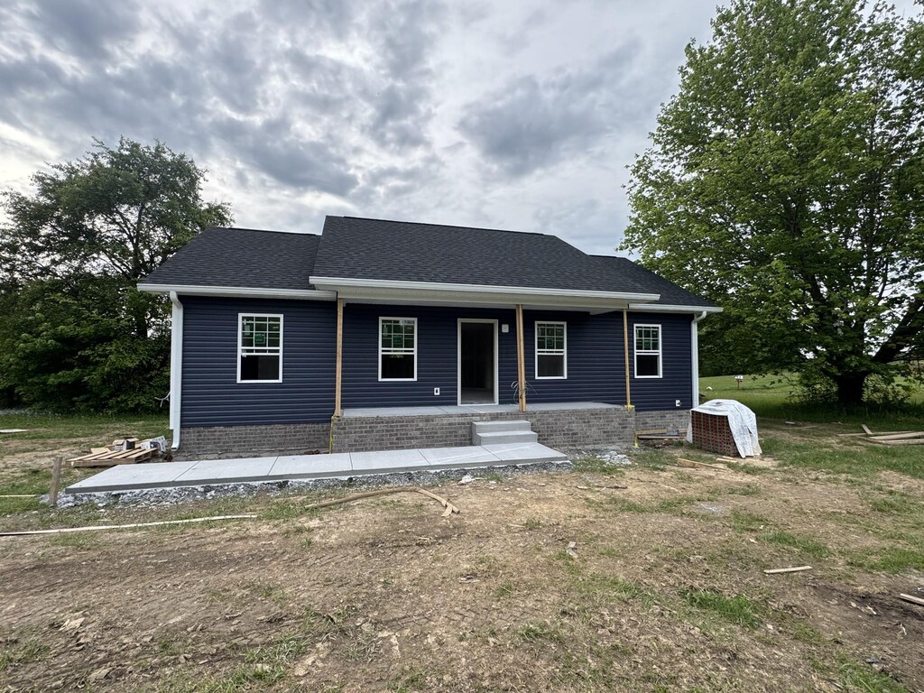 view of front of property featuring roof with shingles, central AC, and covered porch