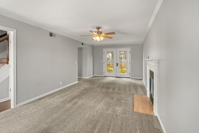 unfurnished living room with ornamental molding, carpet, and a textured ceiling
