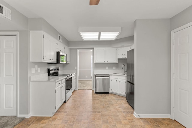 kitchen with visible vents, a sink, white cabinetry, and appliances with stainless steel finishes