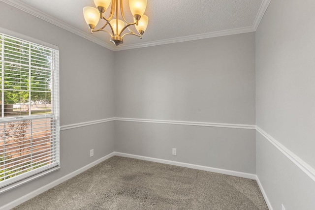 carpeted spare room with crown molding, baseboards, and a notable chandelier