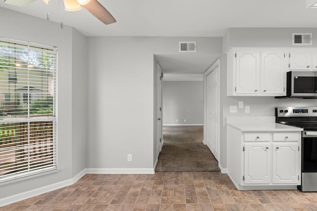 kitchen featuring a ceiling fan, visible vents, light countertops, white cabinets, and stainless steel appliances