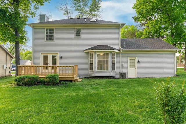 back of house with a yard, a wooden deck, french doors, and a chimney