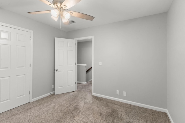 unfurnished bedroom with baseboards, a ceiling fan, and carpet flooring