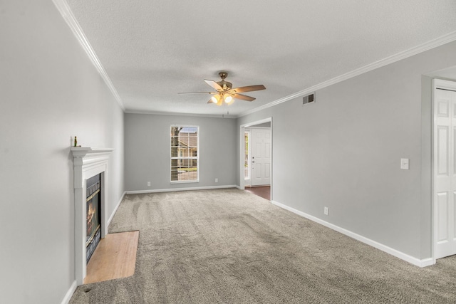 unfurnished living room featuring carpet floors, ornamental molding, and visible vents