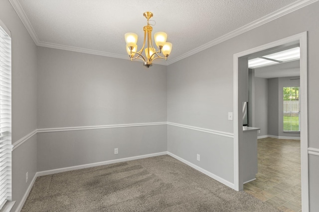 unfurnished room featuring crown molding, a textured ceiling, baseboards, and a notable chandelier