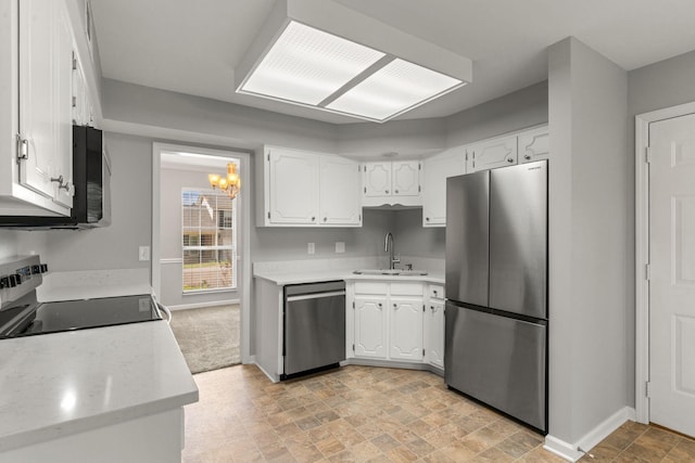 kitchen with a sink, appliances with stainless steel finishes, and white cabinets