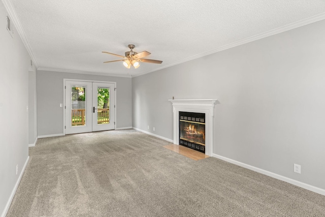 unfurnished living room with crown molding, a ceiling fan, a textured ceiling, and carpet