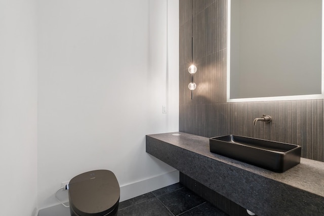bathroom with a sink and baseboards