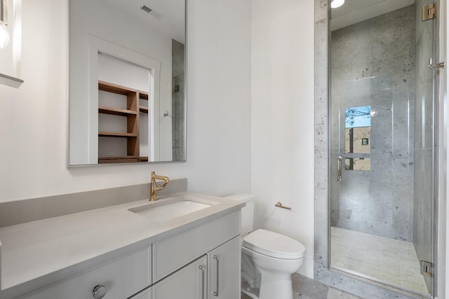 bathroom with vanity, toilet, visible vents, and a stall shower