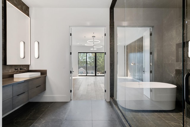 bathroom with vanity and a soaking tub
