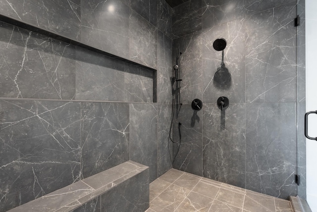 bathroom featuring a marble finish shower