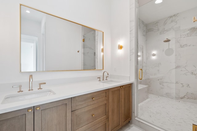 full bath featuring double vanity, a marble finish shower, a sink, and marble finish floor