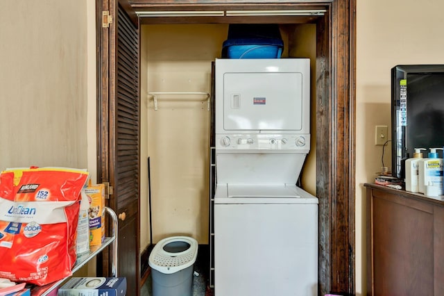 clothes washing area featuring laundry area and stacked washer and clothes dryer