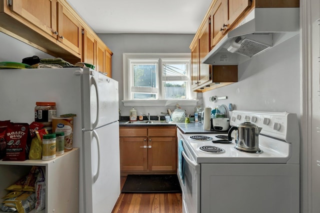 kitchen with under cabinet range hood, dark wood-style flooring, white appliances, a sink, and brown cabinets