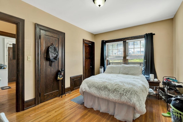 bedroom featuring baseboards and light wood-type flooring