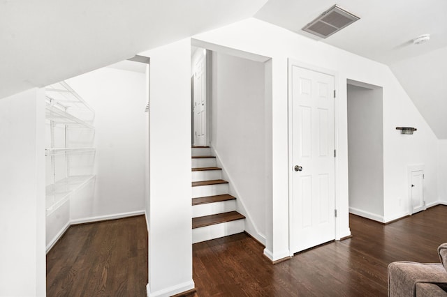 interior space featuring visible vents, wood finished floors, and vaulted ceiling