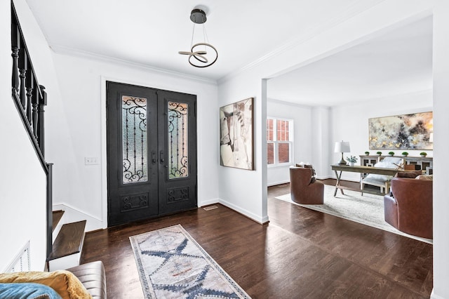 entrance foyer featuring french doors, visible vents, wood finished floors, ornamental molding, and stairs