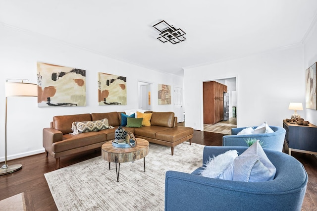 living area featuring crown molding, baseboards, and wood finished floors