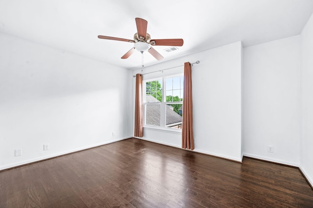 unfurnished room featuring baseboards, a ceiling fan, wood finished floors, and visible vents