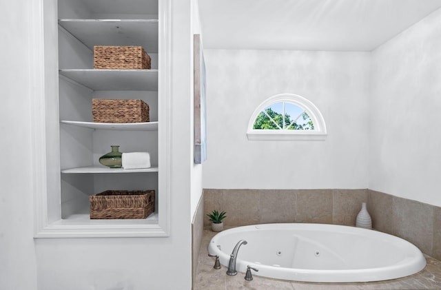 bathroom with a tub with jets